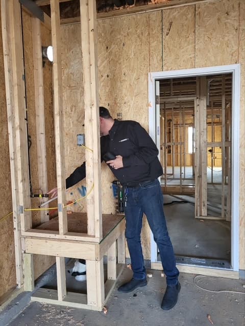 Dean inspecting new construction framing