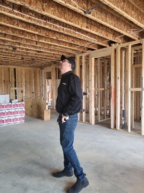 Dean looking up at ceiling structure