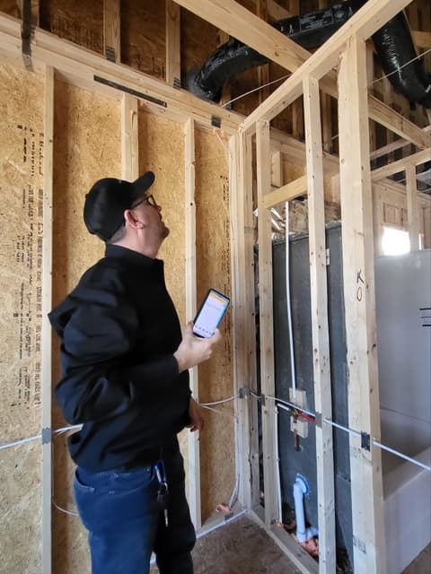 Dean reviewing framing with phone