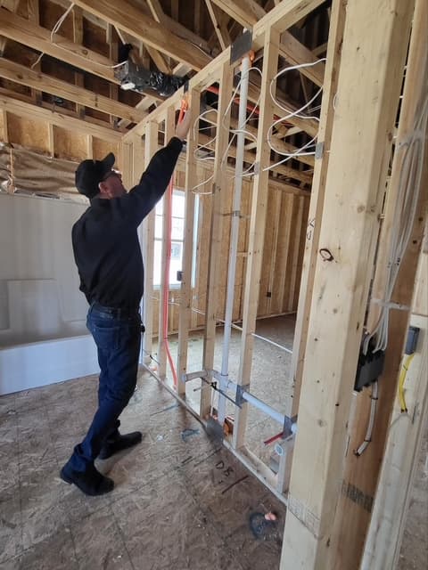 Dean checking overhead electrical and junction box