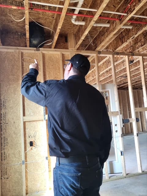 Dean pointing at ceiling joists